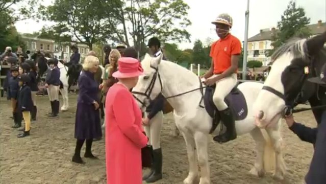Queen talks to a horse, while Camilla feeds them sweets