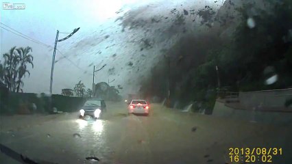 Driver is nearly crushed by a giant rock after landslide ... scary!