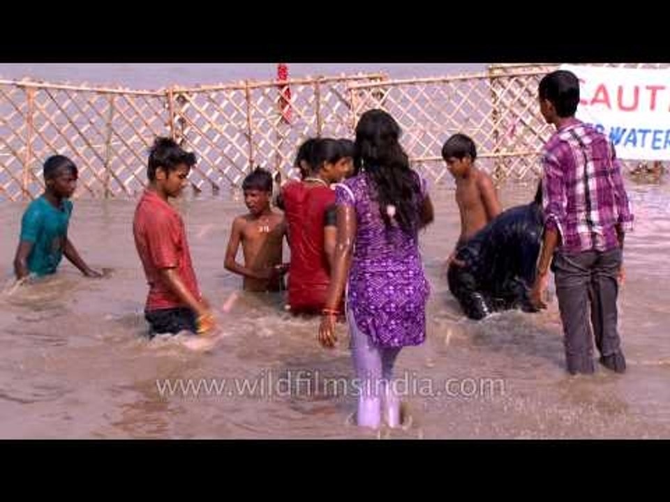 Devotees throng the dirty Yamuna river-bank during Durga Visarjan