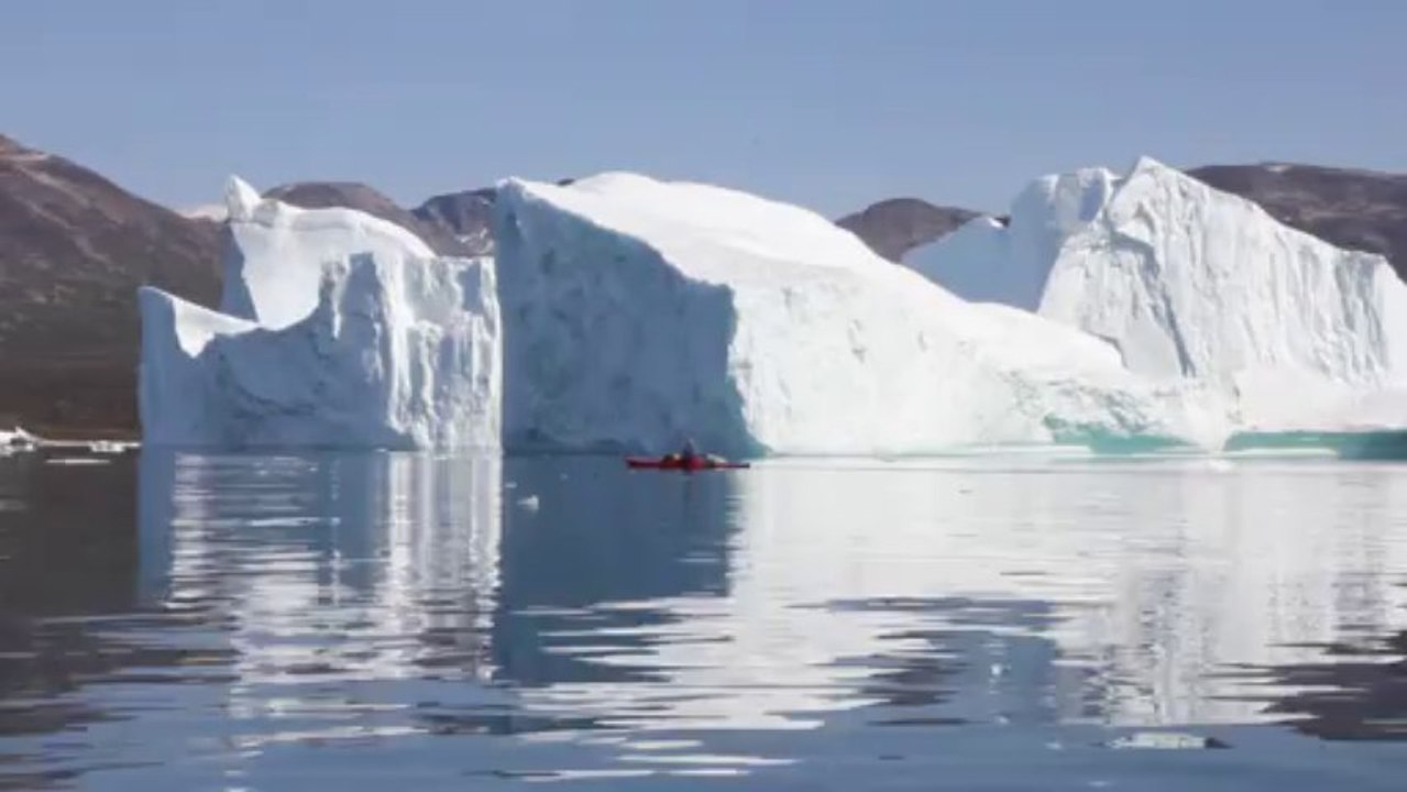 Kayak between Disko Bay icebergs