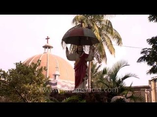 Statue of Jesus Christ in front of garden at St. Joseph's Church