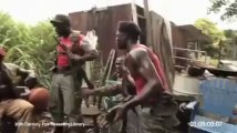 Monkey shooting AK-47 Between Soldiers in...