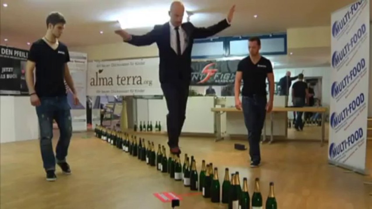 Watch man break record for walking on bottles