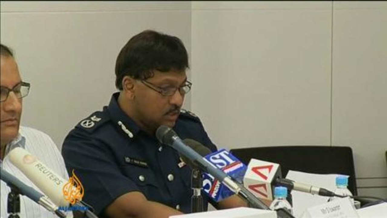 Police cars set alight in Singapore riot