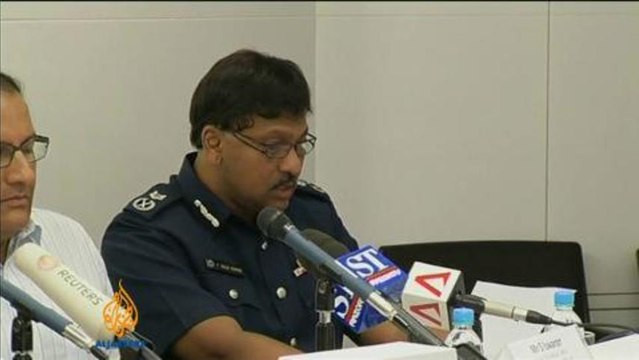 Police cars set alight in Singapore riot