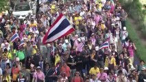 Thai PM calls elections as 140,000 join protest