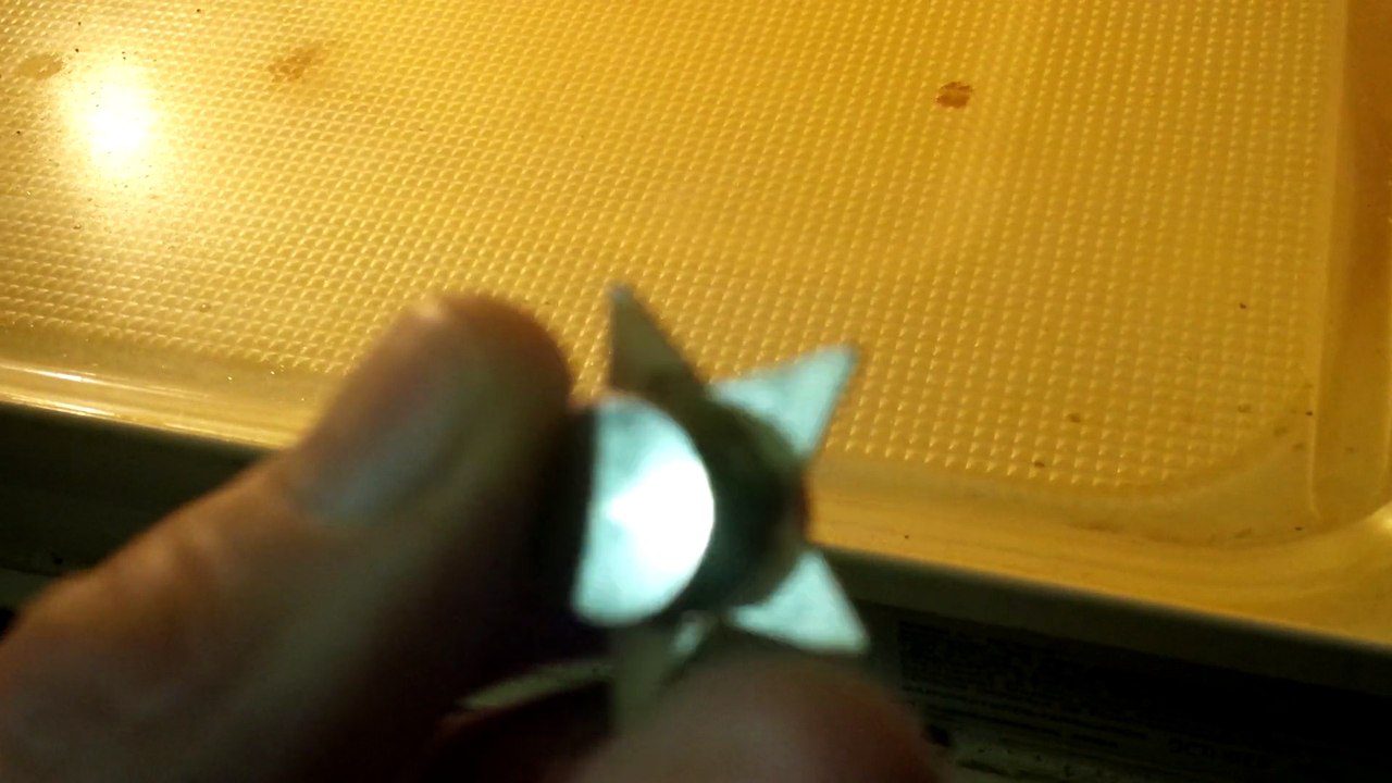 A broken magnetic clip-on LED shirt decal gets microwaved when I found it did not work with a new set of button cell batteries at all