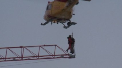 Man rescued from crane as fire burned
