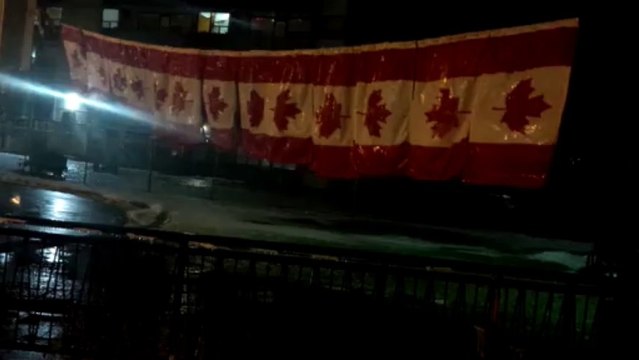 A short video about a set of 14 frozen canadian flags as a result of the ice storm hitting toronto canada