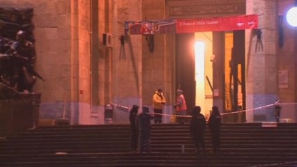 Russian crews work to clean up the bloodied scene of a suicide attack