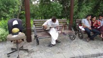 Folk musician playing Rubab at Daman-e-Koh Margalla Hills Islamabad Pakistan
