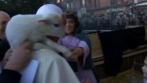 Pope carries lamb on shoulders during visit to nativity scene