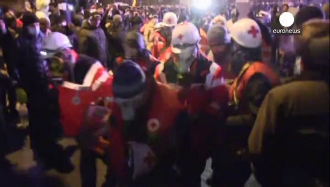 Dozens injured in Kyiv after clashes with riot...