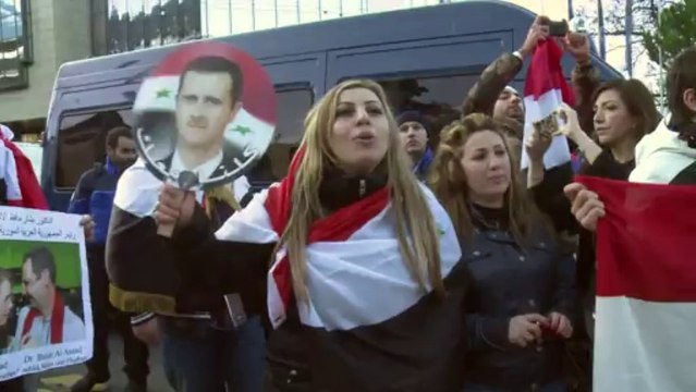 Pro-regime protesters rally outside Syria talks
