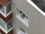 baby walking on edge of balcony window