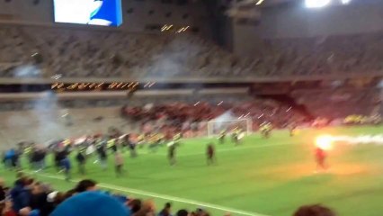 Soccer Fans Light Flares, Storm Field