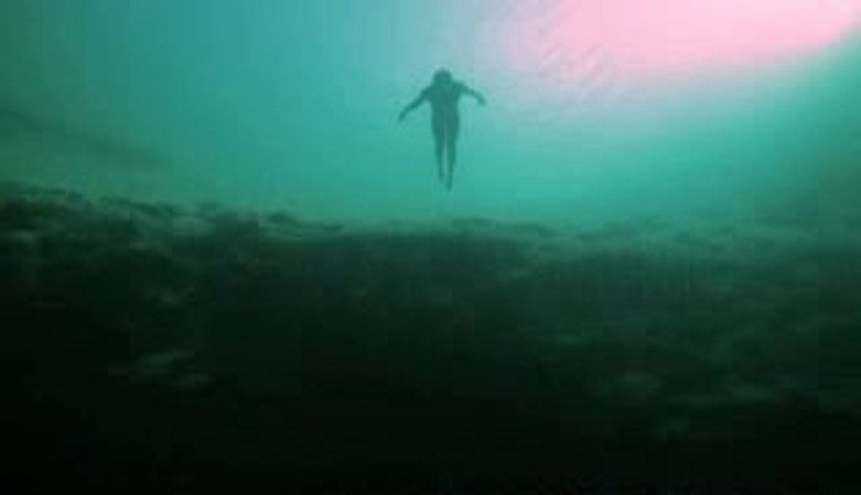 Guillaume Nery base jumping at Dean's Blue Hole, filmed on breath hold by Julie Gautier
