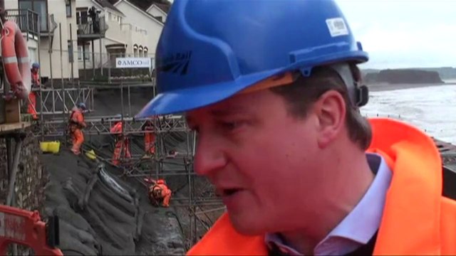 Britain's Cameron visits flood zone as anger mounts