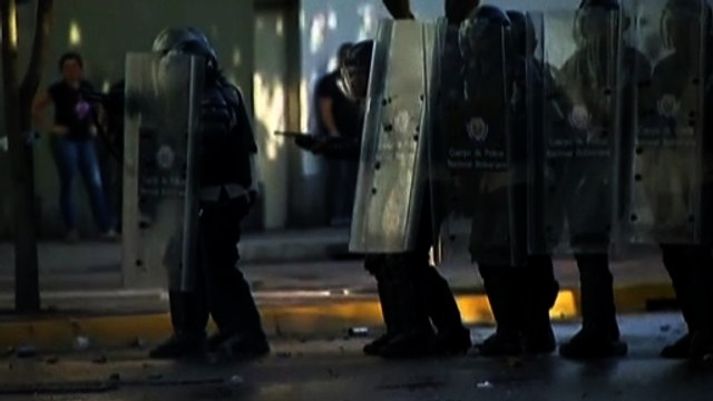 Demonstrators clash with riot police in Caracas