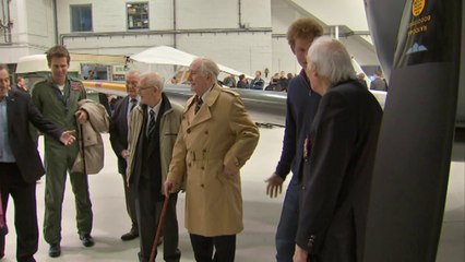 Prince Harry climbs into a Spitfire at Goodwood