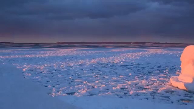 Waves of Ice Wash Against Lake Michigan Shore