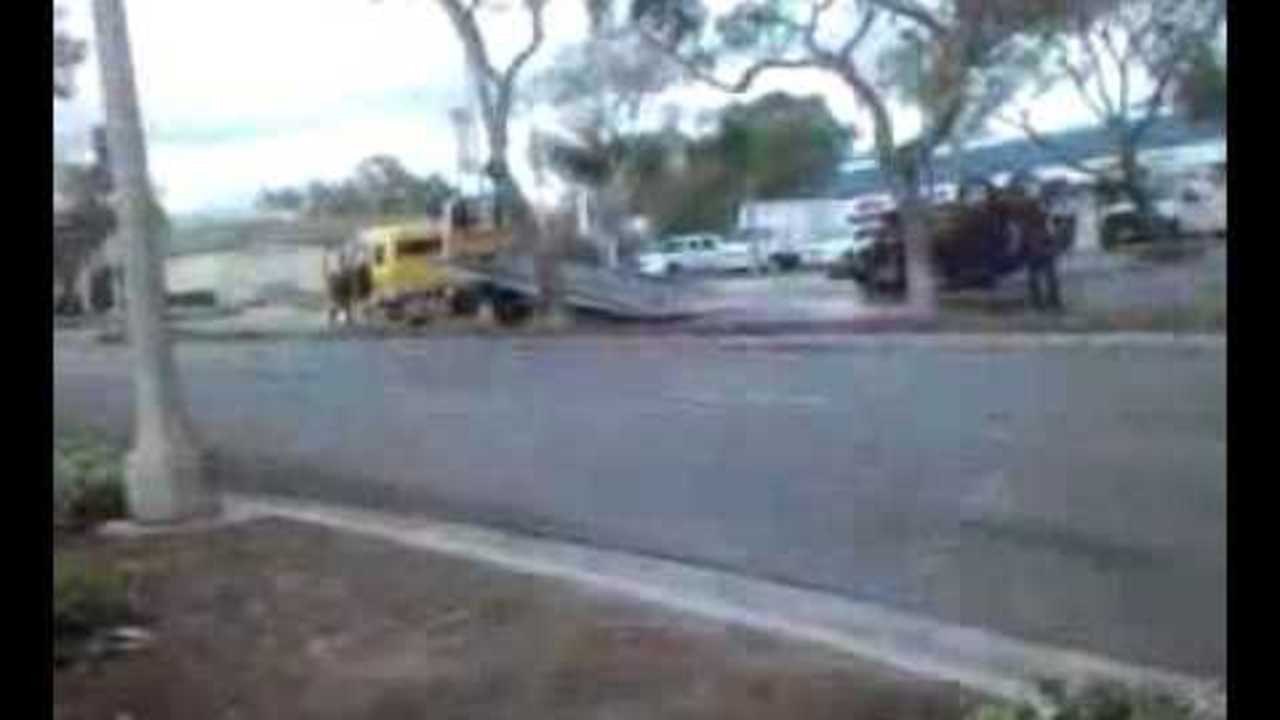 Car upside down in street (GRAPHIC)