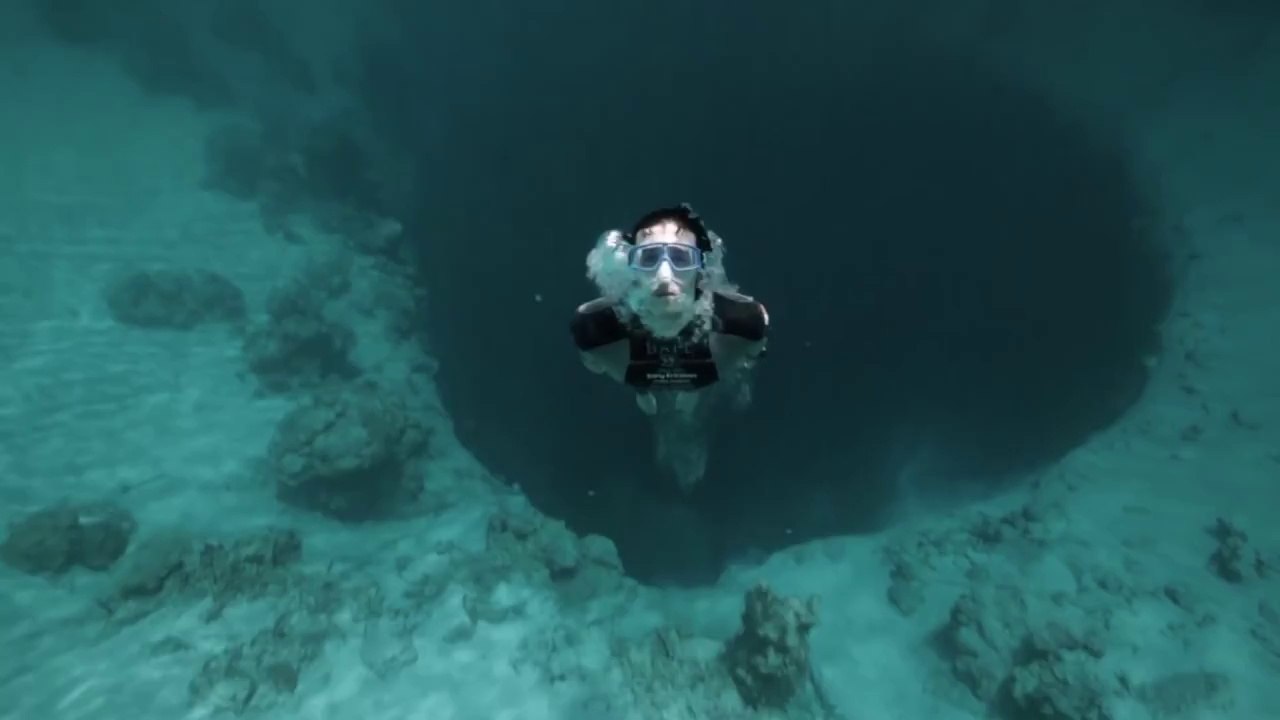 Guillaume Nery base jumping at Dean's Blue Hole - filmed on breath hold by Julie Gautier