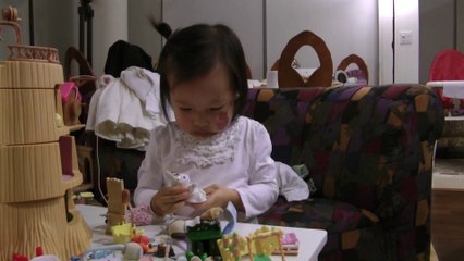 Girl Changing Dress For Her Doll