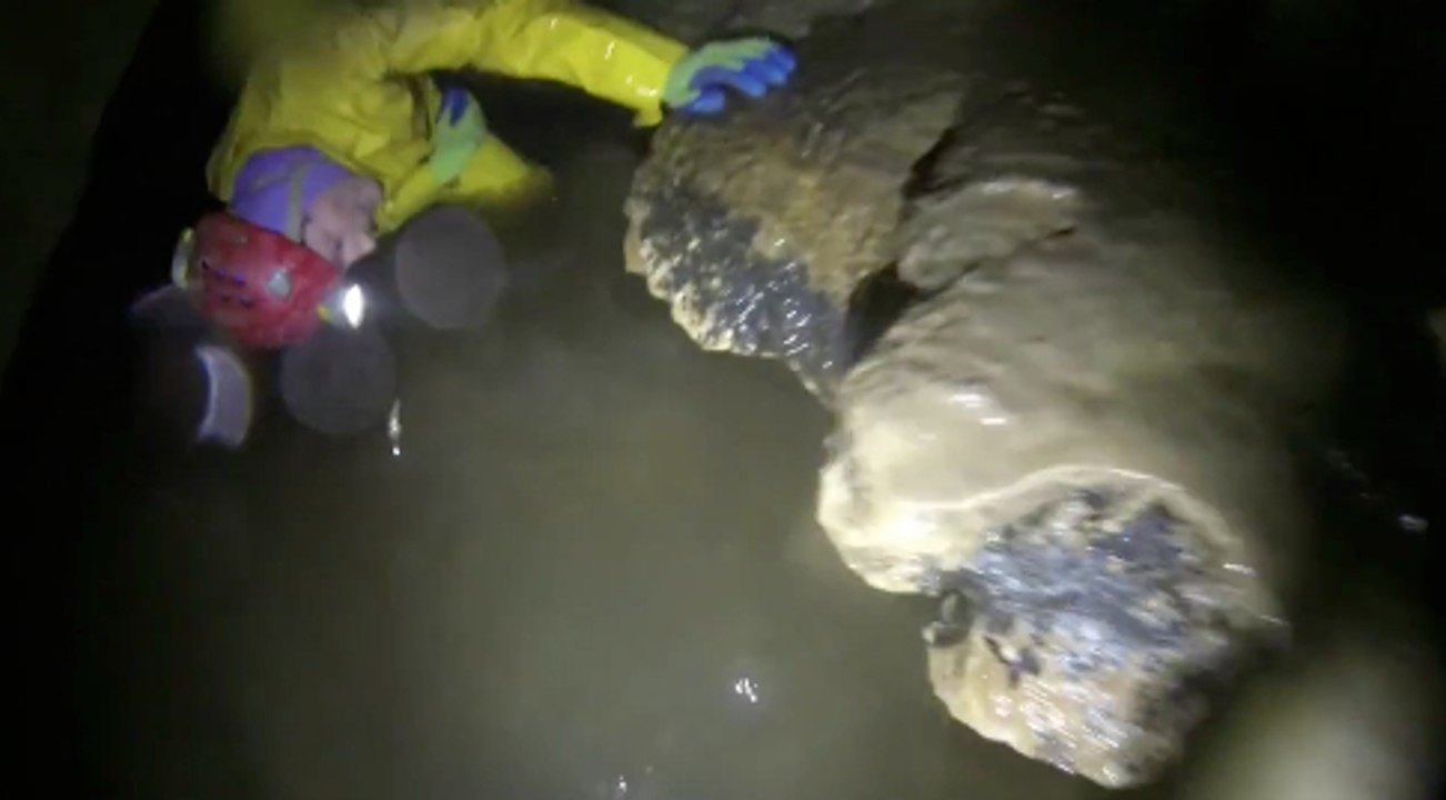 Caving - A man trapped in a cave that is filled with water