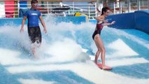 Amateur surfers wiping out on a surf machine