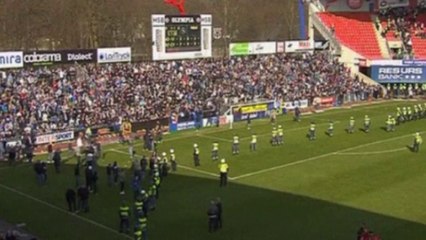 Pitch invasion and tense standoff during football match