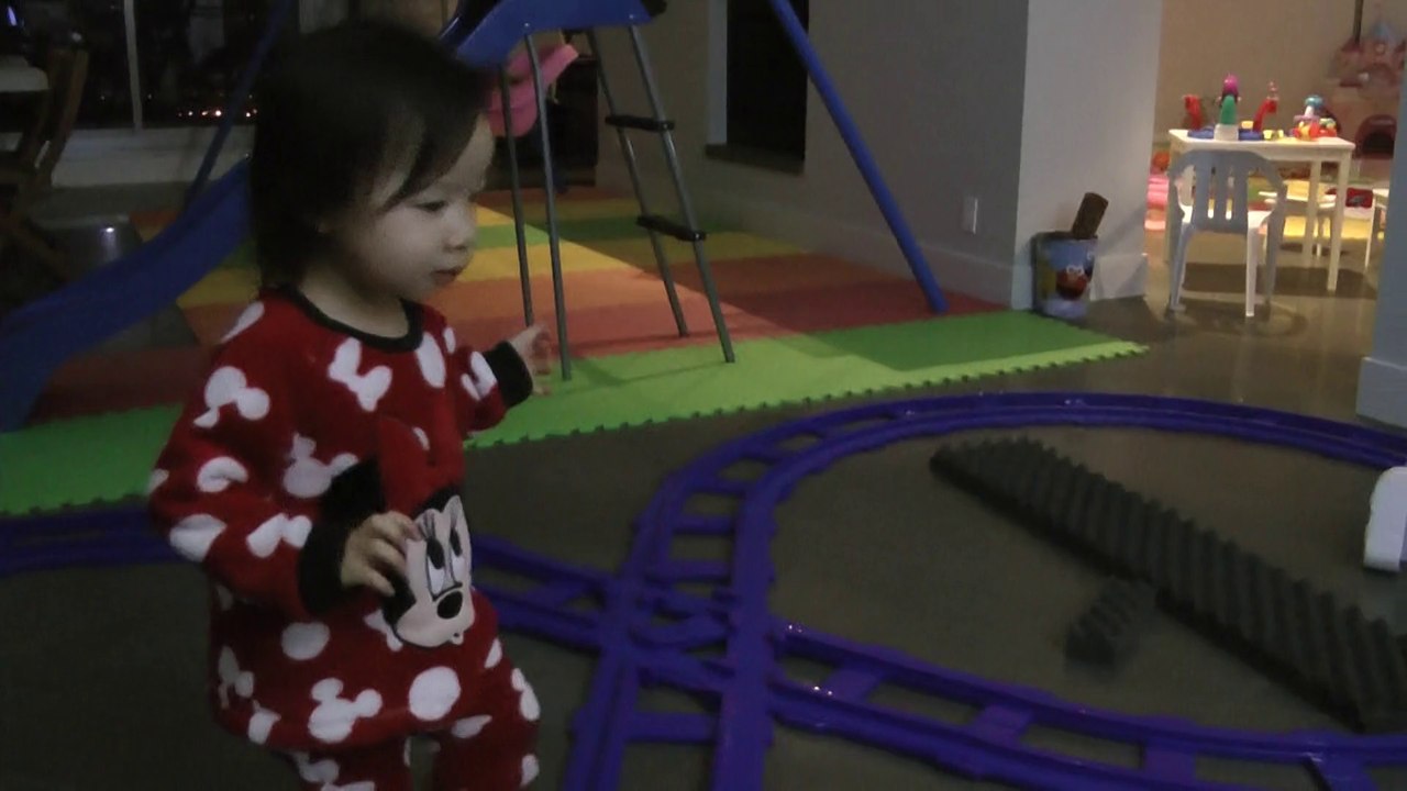 Girl Trying To Drive Toy Train