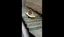 Kid surfing down the stairs!