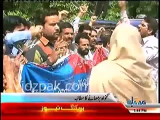 One of the several paramedics, protesting outside Jinnah Hospital Lahore, climbs up to tree