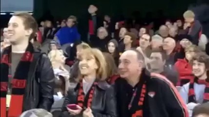 This man put the  finger in his nose in stadium watch.