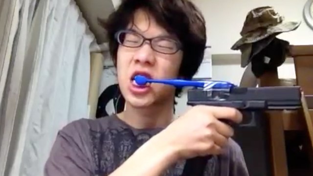Japanese Kid Brushes His Teeth with a Gun