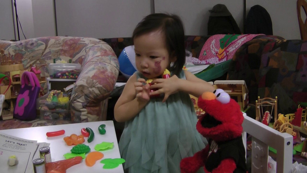 Girl Feeding Elmo
