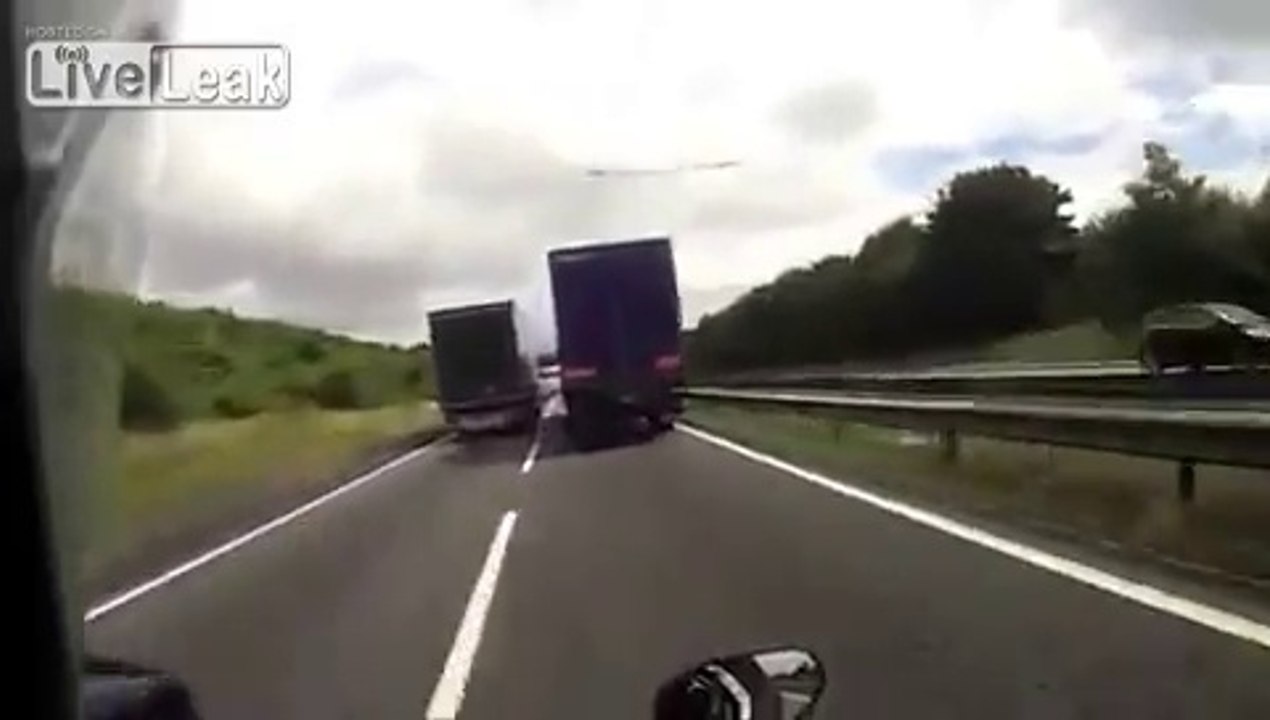 Motorcycle crash between two trucks