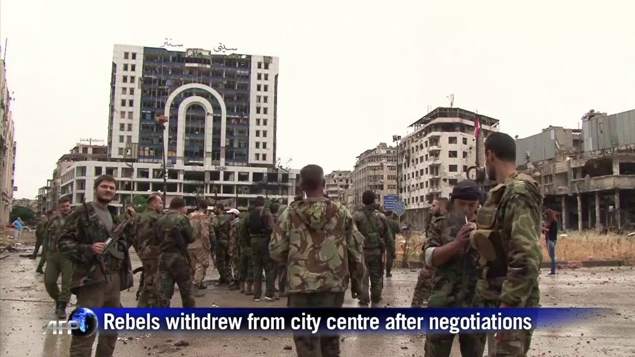 Syrian government forces celebrate in Homs