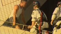 Man climbs to top of one of the Sydney Opera House sails