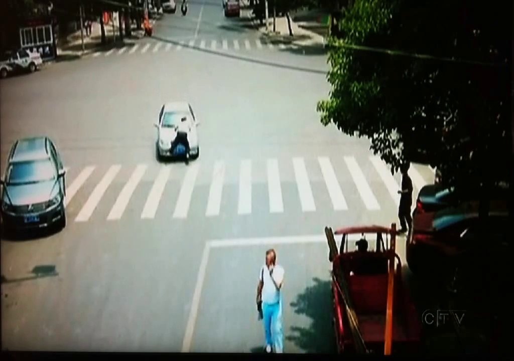 cop hangs on to car!