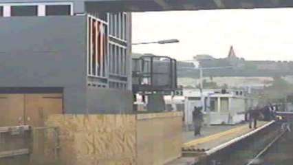 Dramatic moment man jumps onto railway track to save woman