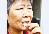 Old Woman Chews on Glass and Stones