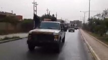 Islamic militants parade in captured Iraqi military vehicles in Mosul