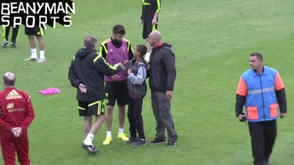 World Cup 2014 - Gerard Pique Gives His Tracksuit Top To Young Pitch Invader