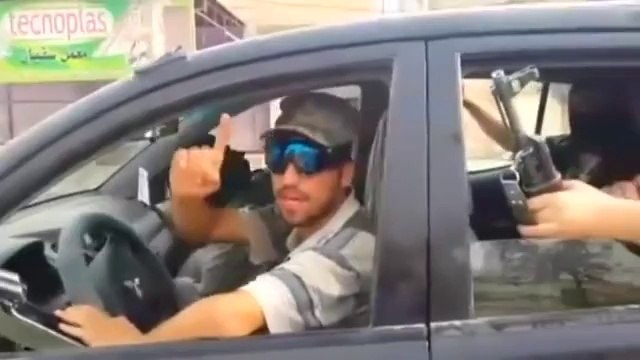 Islamic militants parade in captured Iraqi military vehicles