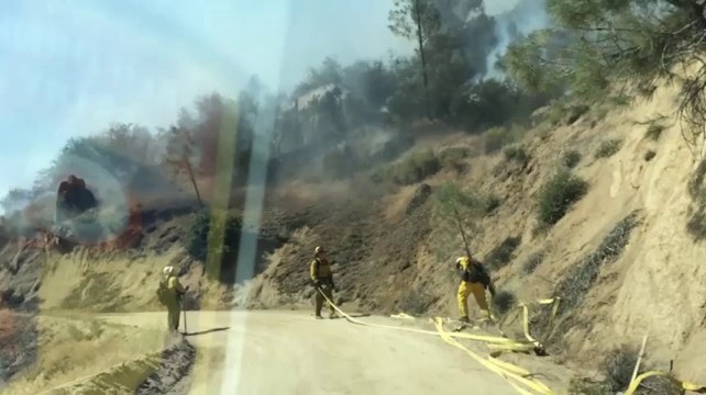 Raw: Calif. fire grows slightly, threatens homes
