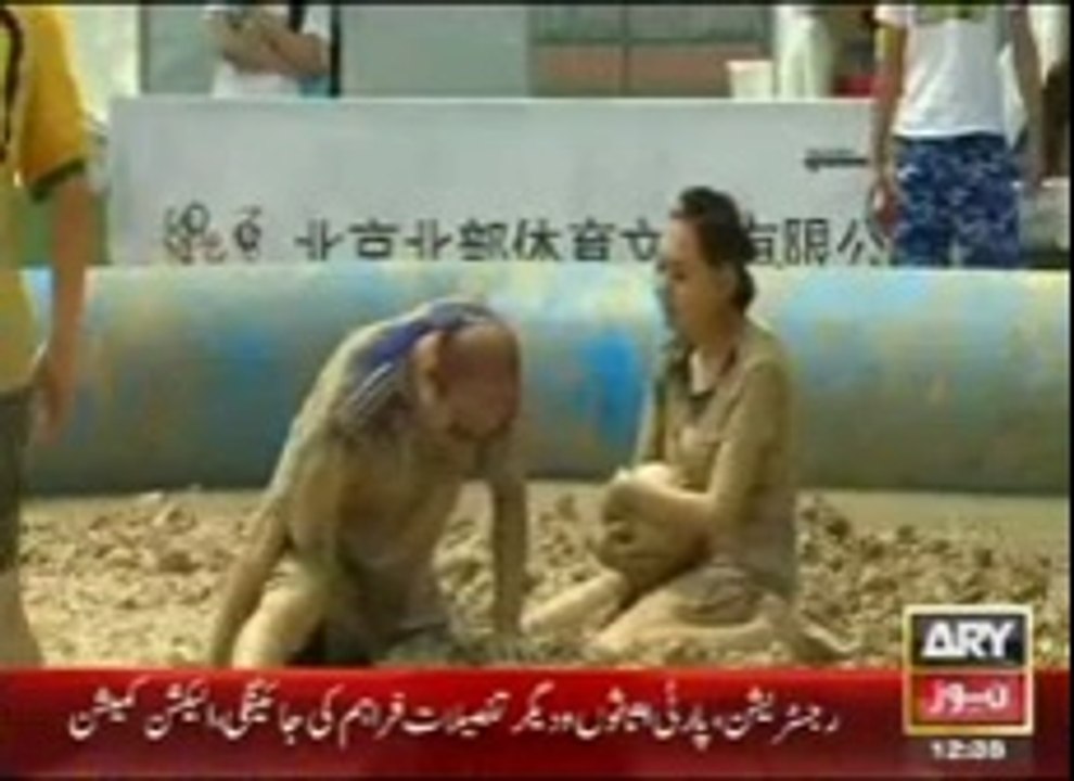 Chinese play Football in mud
