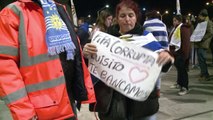 Flag-waving Uruguayans flock to airport to wait for Suarez