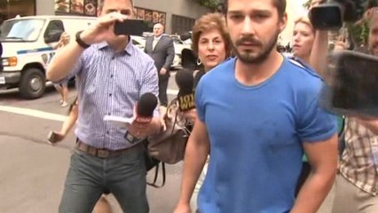 Shia LaBeouf surrounded by reporters after leaving Manhattan court